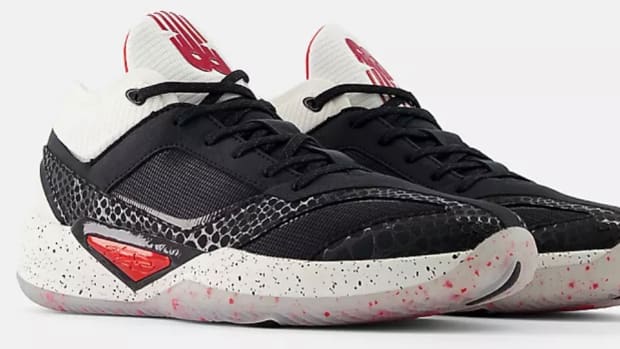 Side view of black and white New Balance shoes.